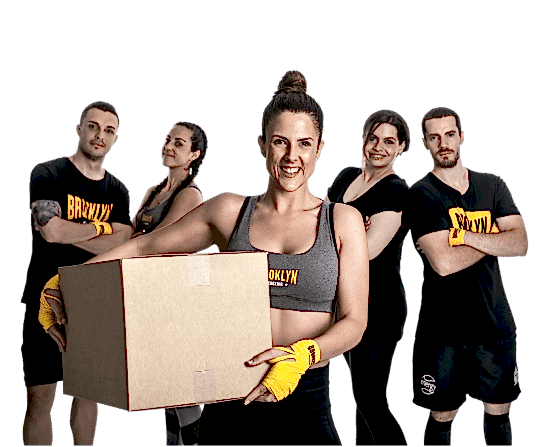 Fitboxer in the foreground holding a box engraved with the words "Hit 4 Change."